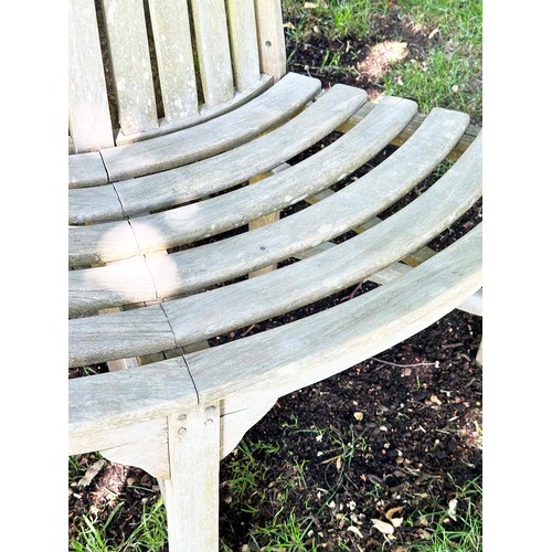 139 - GARDEN TREE BENCH, nicely weathered teak forming half round (two quadrants) of slatted form with upr... 