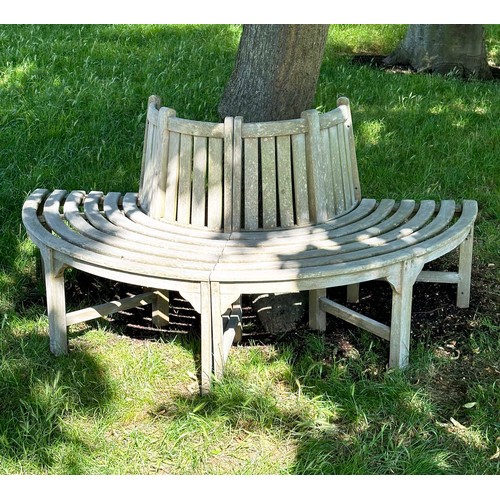 139 - GARDEN TREE BENCH, nicely weathered teak forming half round (two quadrants) of slatted form with upr... 