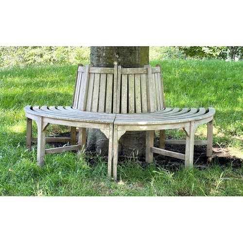 139 - GARDEN TREE BENCH, nicely weathered teak forming half round (two quadrants) of slatted form with upr... 