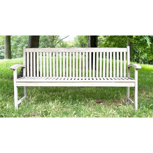 137 - GARDEN BENCH, well weathered teak slatted with slightly arched arms, 165cm W.