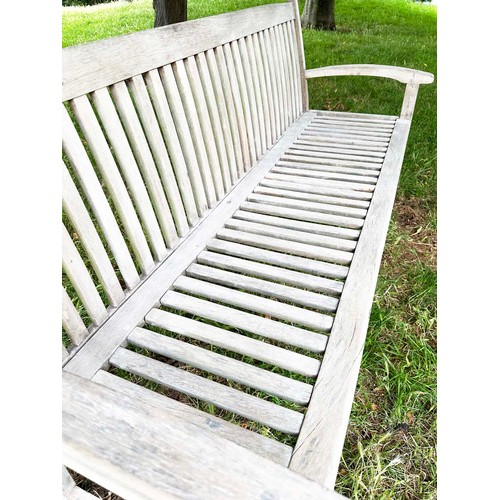 137 - GARDEN BENCH, well weathered teak slatted with slightly arched arms, 165cm W.