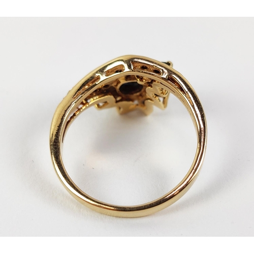 18 - A YELLOW METAL SAPPHIRE AND DIAMOND SET DRESS RING, probably 18ct gold, asymmetrical floral spray wi... 