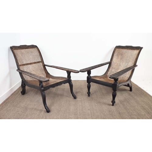 150 - PLANTERS CHAIRS, a near pair, 19th century Anglo-Indian ebony with cane seats and carved frames, 93c... 