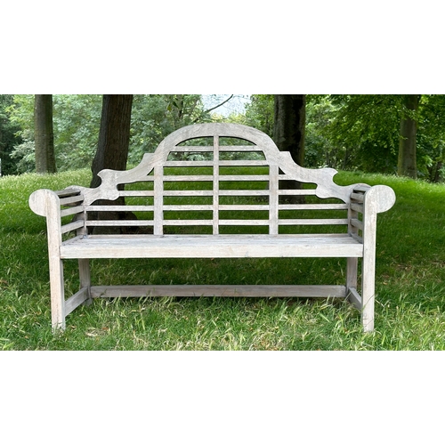 191 - LUTYEN GARDEN BENCH, well weathered teak of slatted and dowelled construction after the design by Si... 