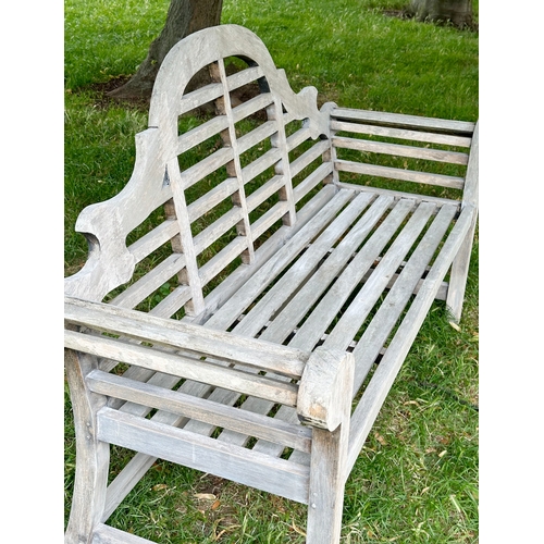 191 - LUTYEN GARDEN BENCH, well weathered teak of slatted and dowelled construction after the design by Si... 