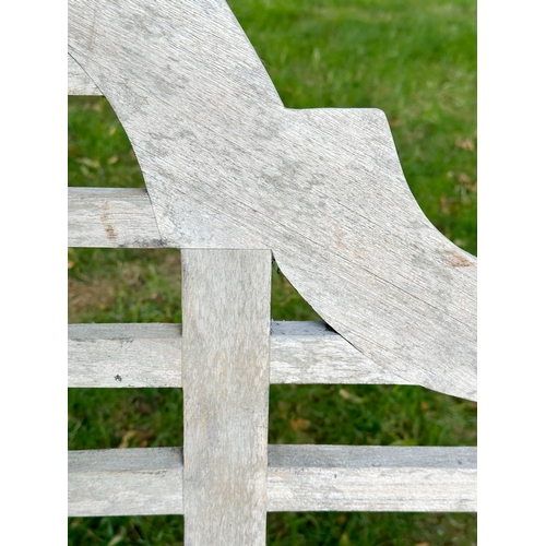 191 - LUTYEN GARDEN BENCH, well weathered teak of slatted and dowelled construction after the design by Si... 