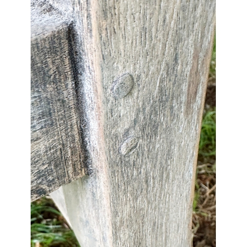 191 - LUTYEN GARDEN BENCH, well weathered teak of slatted and dowelled construction after the design by Si... 