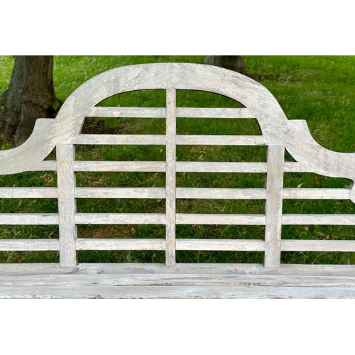 191 - LUTYEN GARDEN BENCH, well weathered teak of slatted and dowelled construction after the design by Si... 