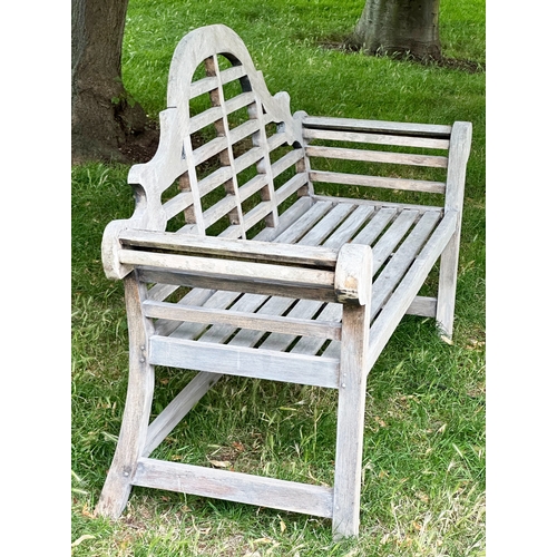 191 - LUTYEN GARDEN BENCH, well weathered teak of slatted and dowelled construction after the design by Si... 