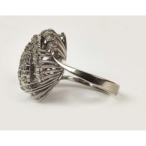 26 - AN 18CT WHITE GOLD DIAMOND CLUSTER RING, in a swirl design, the central round brilliant cut stone of... 