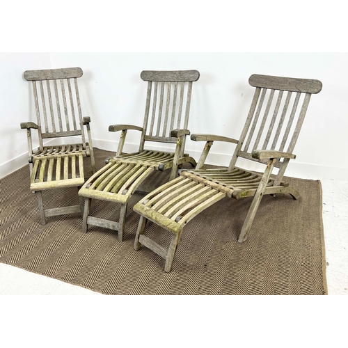 157 - GARDEN STEAMER CHAIRS, a set of three, folding weathered teak with cushions. (3)