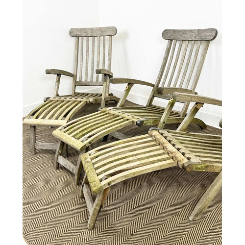 157 - GARDEN STEAMER CHAIRS, a set of three, folding weathered teak with cushions. (3)