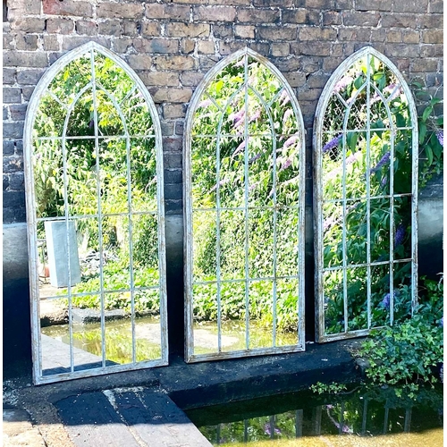 349 - ARCHITECTURAL GARDEN MIRRORS, a set of three, arched metal frames, 160cm H x 67cm W. (3)