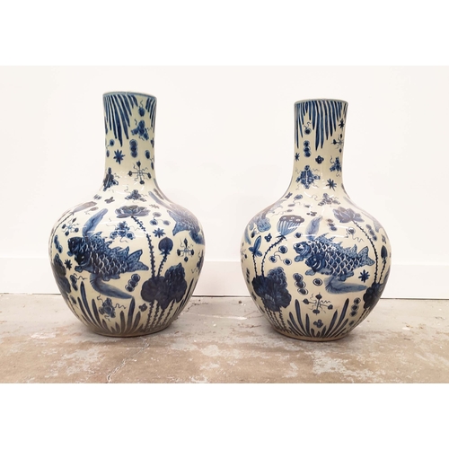 394 - BOTTLES NECK VASES, a pair, Chinese style blue and white ceramic, 56cm H x 38cm W. (2)