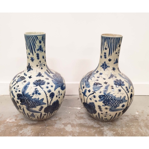 394 - BOTTLES NECK VASES, a pair, Chinese style blue and white ceramic, 56cm H x 38cm W. (2)