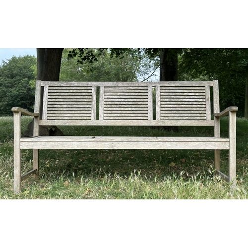 111 - GARDEN BENCH, early 20th century English well weathered teak with close strutted seats and back pane... 