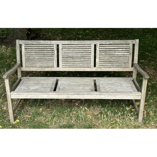 111 - GARDEN BENCH, early 20th century English well weathered teak with close strutted seats and back pane... 