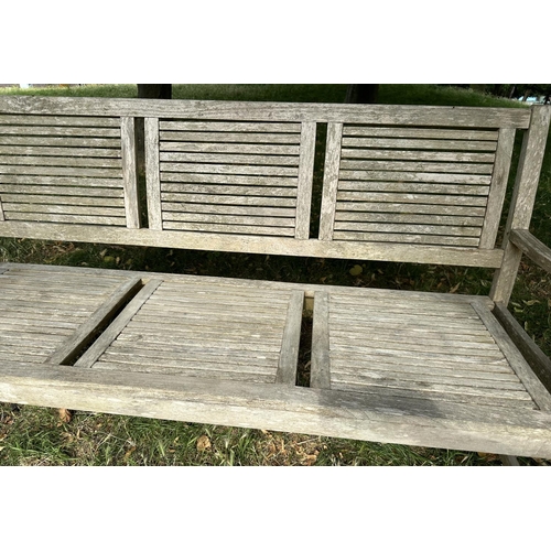 111 - GARDEN BENCH, early 20th century English well weathered teak with close strutted seats and back pane... 