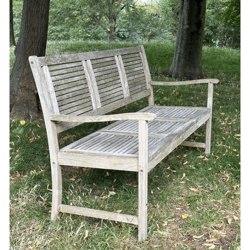 111 - GARDEN BENCH, early 20th century English well weathered teak with close strutted seats and back pane... 