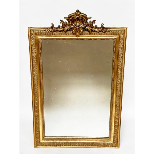 82 - WALL MIRROR, 19th century French giltwood, rectangular with gesso beaded and foliate frame and shell... 