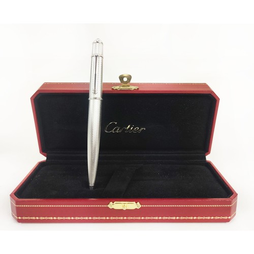 7 - A CARTIER WHITE METAL BALLPOINT PEN, engine turned decoration, blue resin cabouchon to end, complete... 