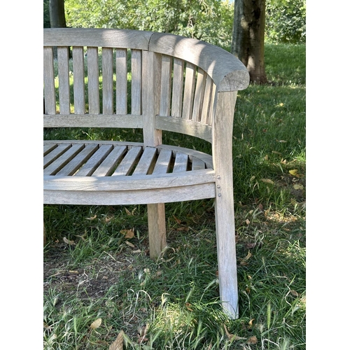 118 - BANANA GARDEN BENCH, well weathered teak, slatted and dowelled with curved back, 160cm W.