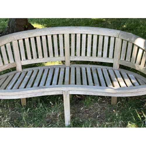 118 - BANANA GARDEN BENCH, well weathered teak, slatted and dowelled with curved back, 160cm W.