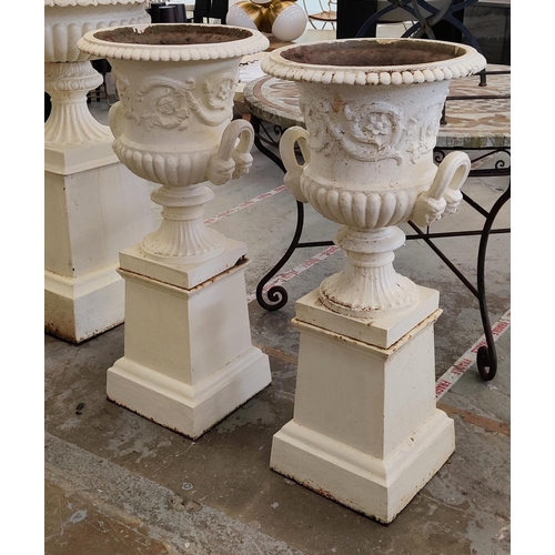 161 - GARDEN URNS, a pair, Victorian cream painted cast iron of campana form on plinths, 100cm H x 46cm D.... 