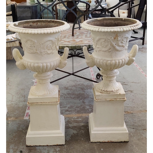 161 - GARDEN URNS, a pair, Victorian cream painted cast iron of campana form on plinths, 100cm H x 46cm D.... 