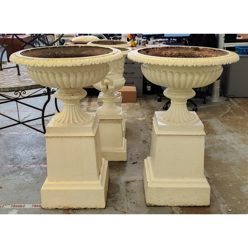 162 - GARDEN URNS, a pair, Victorian cream painted cast iron with gadrooned bowls on plinths, 107cm H x 74... 