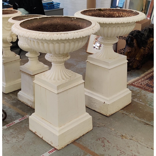 162 - GARDEN URNS, a pair, Victorian cream painted cast iron with gadrooned bowls on plinths, 107cm H x 74... 