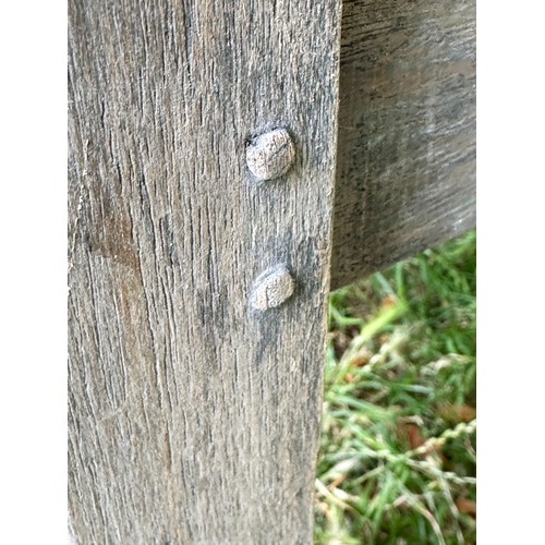 114 - 'LUTYENS' STYLE GARDEN BENCH, weathered teak slatted and dowelled construction after the design by S... 