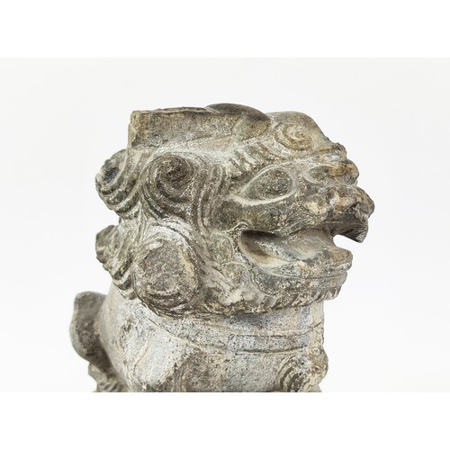 31A - A GREY STONE CARVED RELIEF OF A MYTHICAL BEAST, Ming Dynasty style, together with a pair of carved s... 