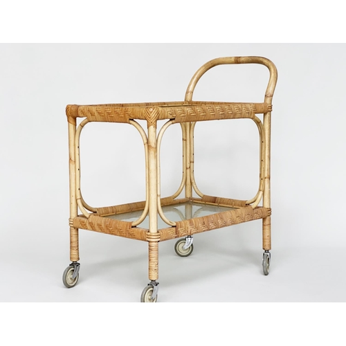 107 - TEA TROLLEY, mid 20th century rattan framed and cane bound with two ripple glass shelves and castors... 