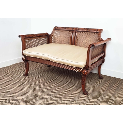 127 - BERGERE SOFA, Regency style beechwood, ebonised and caned with squab cushion, 86cm H x 136cm W x 68c... 