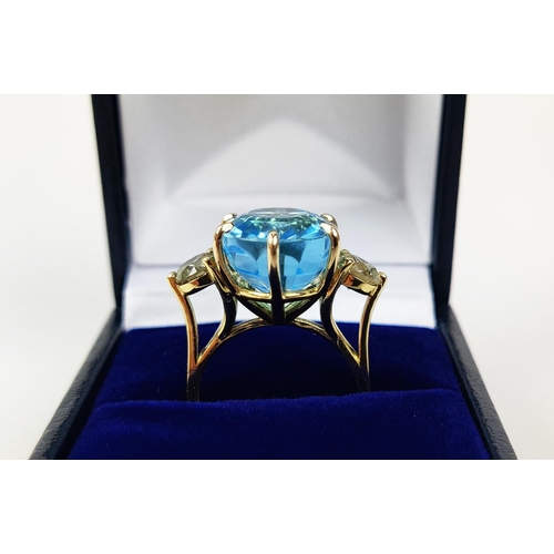 13 - AN 18CT YELLOW GOLD BLUE TOPAZ AND DIAMOND DRESS RING, the central mixed cut topaz of approximately ... 