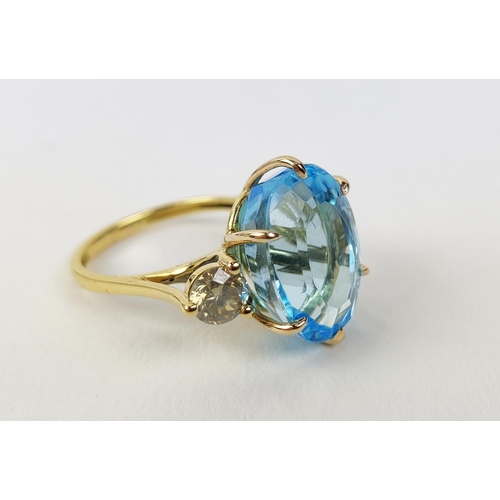 13 - AN 18CT YELLOW GOLD BLUE TOPAZ AND DIAMOND DRESS RING, the central mixed cut topaz of approximately ... 