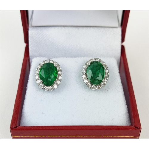 9 - A PAIR OF 18CT WHITE GOLD EMERALD AND DIAMOND STUD EARRINGS, the mixed cut emeralds of 3.20 carats i... 