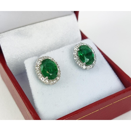 9 - A PAIR OF 18CT WHITE GOLD EMERALD AND DIAMOND STUD EARRINGS, the mixed cut emeralds of 3.20 carats i... 