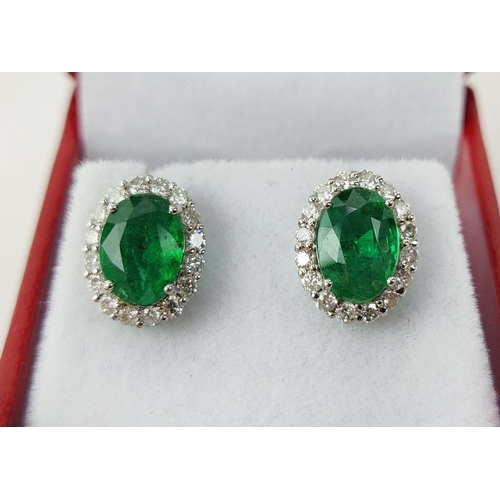 9 - A PAIR OF 18CT WHITE GOLD EMERALD AND DIAMOND STUD EARRINGS, the mixed cut emeralds of 3.20 carats i... 