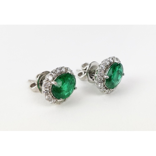 9 - A PAIR OF 18CT WHITE GOLD EMERALD AND DIAMOND STUD EARRINGS, the mixed cut emeralds of 3.20 carats i... 