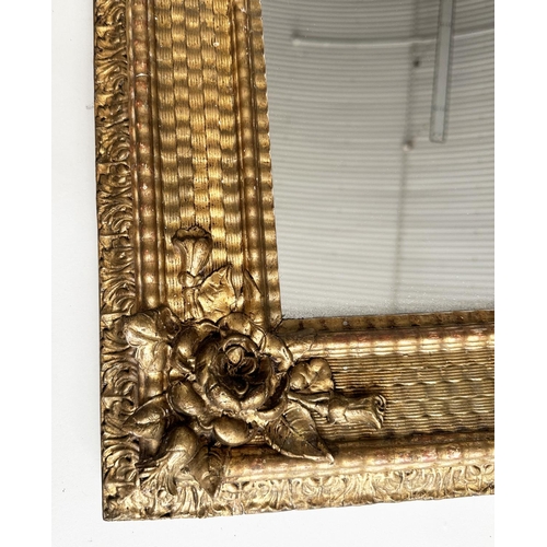 86 - WALL MIRROR, 19th century giltwood and gesso moulded rectangular with ripple moulded frame and rose ... 