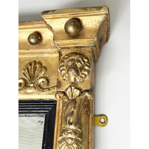 95 - WALL MIRROR, Regency giltwood and gesso moulded with acanthus scroll frieze above a rectangular ebon... 