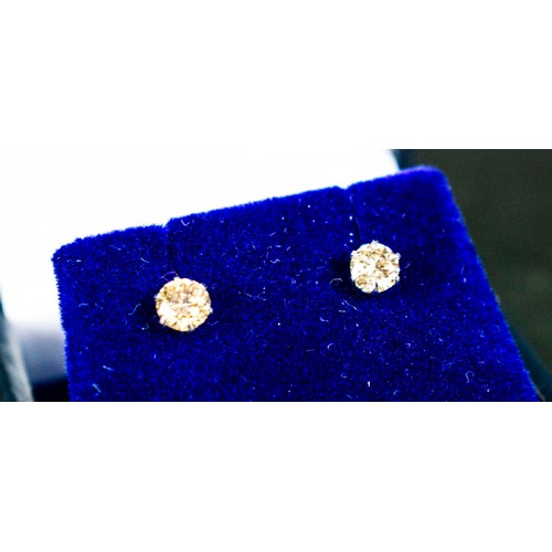 18 - A PAIR OF DIAMOND SOLITAIRE STUD EARRINGS, each claw set with round brilliant cut diamonds of approx... 