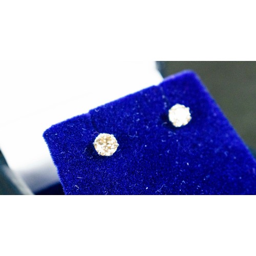 18 - A PAIR OF DIAMOND SOLITAIRE STUD EARRINGS, each claw set with round brilliant cut diamonds of approx... 