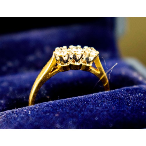 19 - AN 18CT YELLOW GOLD DIAMOND TRILOGY RING, set with three round brilliant cut stones, total carat wei... 