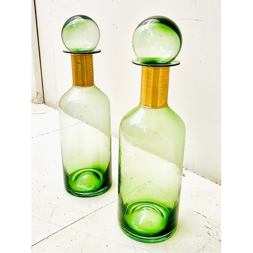 370 - DECANTERS, a pair, green glass with gilt metal collars, 52cm H x 16cm W x 16cm D. (2)