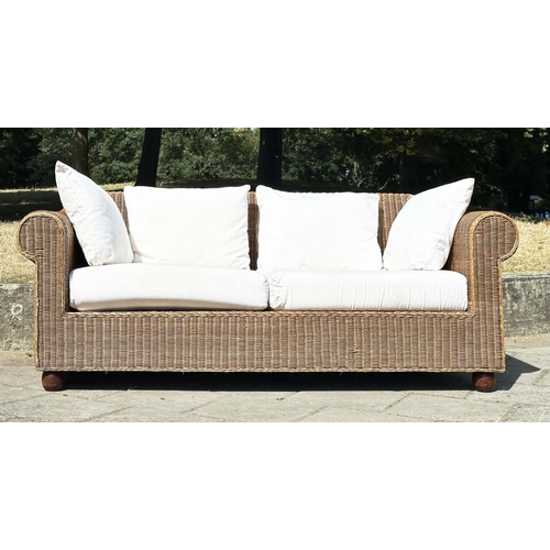 187 - CANE/CONSERVATORY SOFA, woven cane with scroll arms and linen covered cushions, 200cm W.