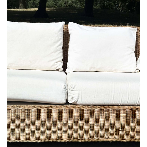 187 - CANE/CONSERVATORY SOFA, woven cane with scroll arms and linen covered cushions, 200cm W.