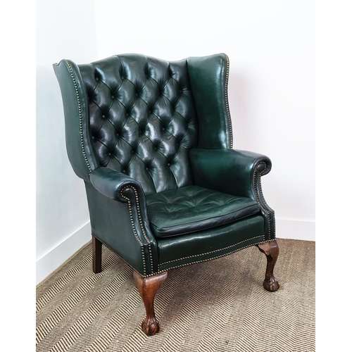 209 - A GEORGE III STYLE WING BACK ARMCHAIR, green leather, raised on cabriole legs with claw and ball fee... 